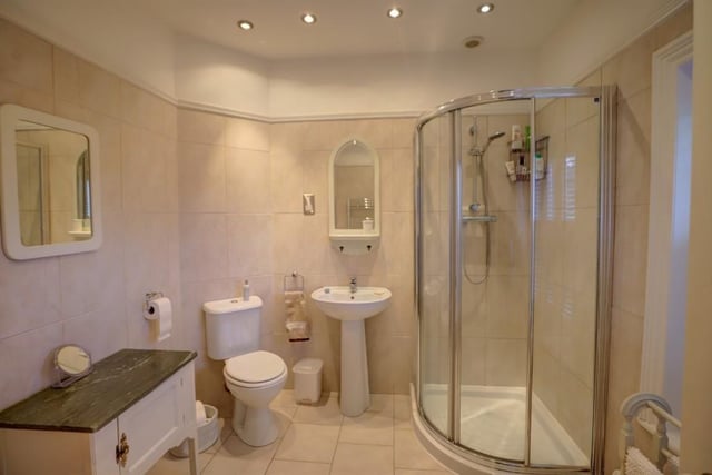 The stylish bathroom with corner shower cubicle.