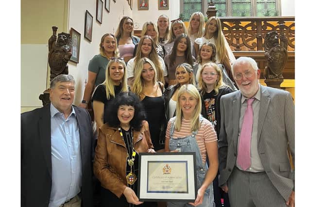 From left to right, Cllr Eric Broadbent, Cllr Roberta Swiers, lead team coach Jess Mortimer and Cllr Tony Randerson with cheerleading champions East Coast Tigers celebrating their remarkable achievements.