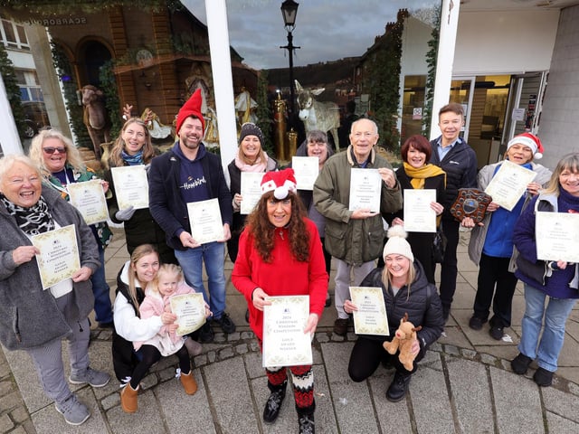 Mayor Janet Jefferson with businesspeople and judges celebrating their winning shop window displays