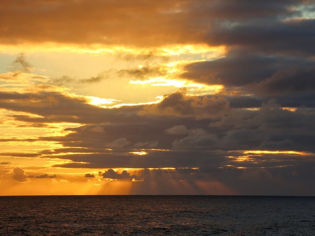 Sun bursting through the clouds.