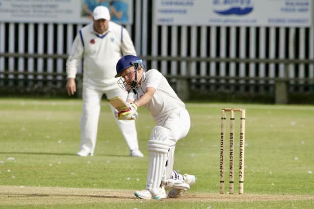 Teenager Alexander Fynn hits out for the home side