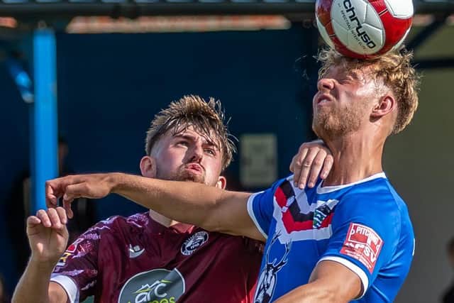 Connor Simpson wins a header for the home side.