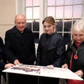 Looking at plans for the Town Hall renovation - L-R - Project officer Kerry Levitt, Cllr Phil Trumper, Dehenna Davison MP and Mayor Linda Wild