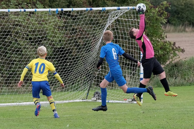 The Heslerton Under-12s keeper is at full stretch to claim this shot from Seamer