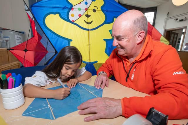 Kite maker and commentator, Alan Poxon, teaches Anne Archer how to make a kite during a workshop in Skipton ahead of the Filey Kite Festival.