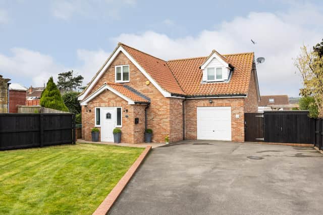 The attractive property has a lawned garden and parking space to the front