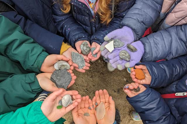 Youngsters showing off their discoveries after some beachcombing fun! Photo: Heather Tennant/NT
