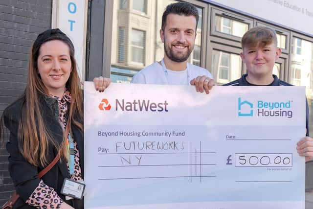Laura Young, Community Partnership & Engagement Manager at Beyond Housing (left) hands a Community Fund cheque for £500 to Futureworks Young Persons Keyworker Lee Sutton (centre) and young person Reggie Stafford (right).