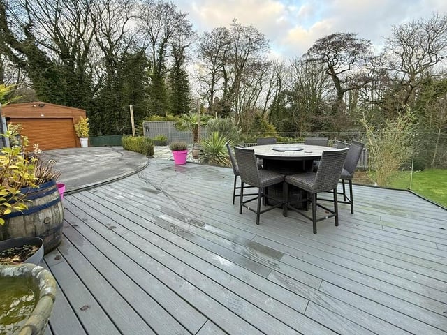 A raised decked area in a garden that's great for entertaining.