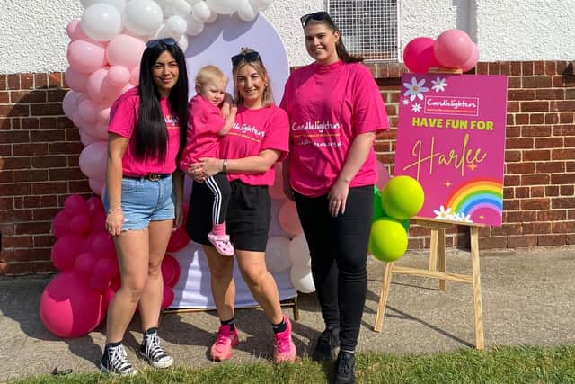 Harlee Breckon is pictured with mum Lisa and friends who helped to organise the fun day event.