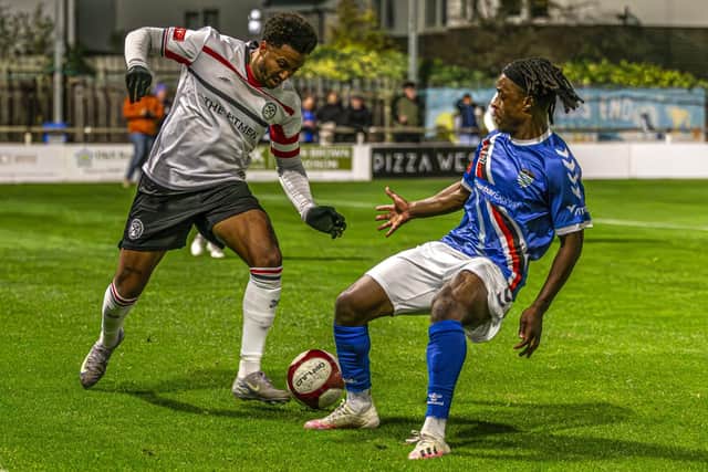 Blues man of the match Donald Chimalilo tries to stop Hednesford's Dom McHale. Phot by Brian Murfield