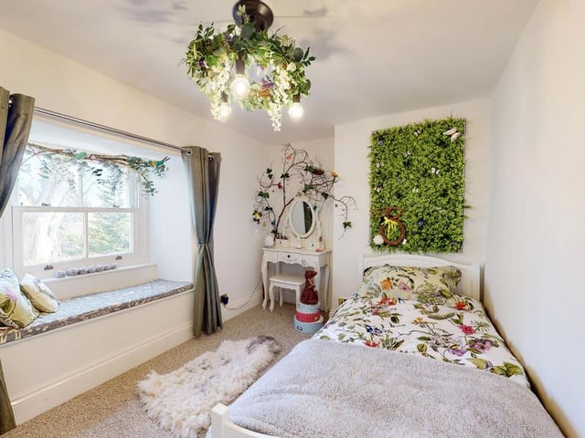 An individually styled bedroom with window seat.