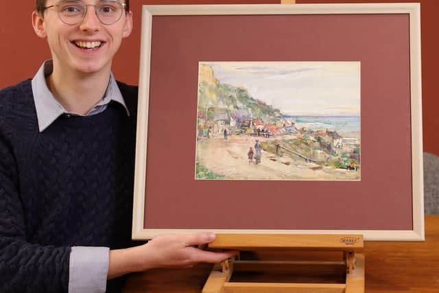 Art specialist Dominic Cox with Brunswick Bay by Staithes Group artist Rowland Hill.