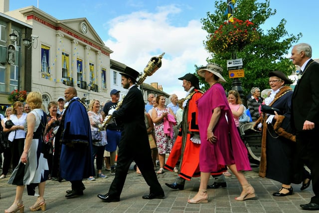 Some of the Yorkshire Mayors ,Dignitries and VIP's walk past the Town Hall in the market square in Ripon parading to the cathedral on Yorkshire Day.