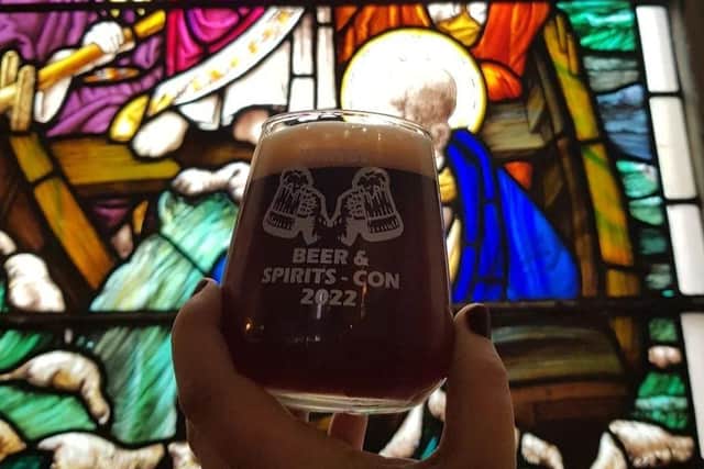 Raising a glass in front of the stained glass!