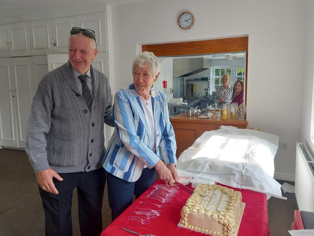 Cutting the cake is Jane Mortimer (honorary president) and Phil Haigh (chair).