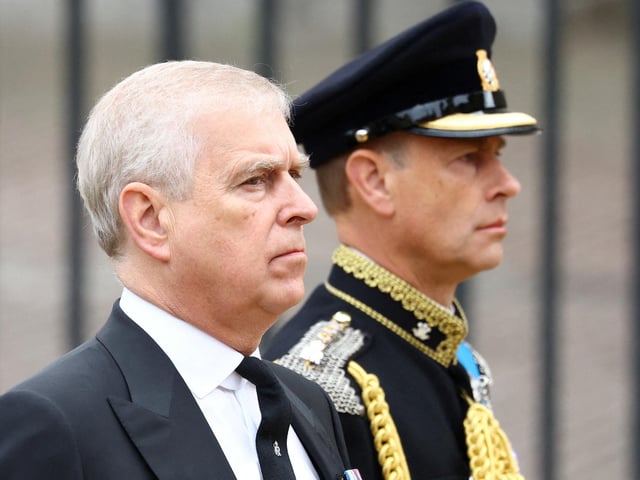 Prince Andrew, Duke of York (L) and Britain's Prince Edward, Earl of Wessex (R) follow a Bearer Party of The Queen's Company, 1st Battalion Grenadier Guards carrying the coffin of Queen Elizabeth II outside Westminster Abbey. (Photo by HANNAH MCKAY / POOL / AFP) (Photo by HANNAH MCKAY/POOL/AFP via Getty Images)