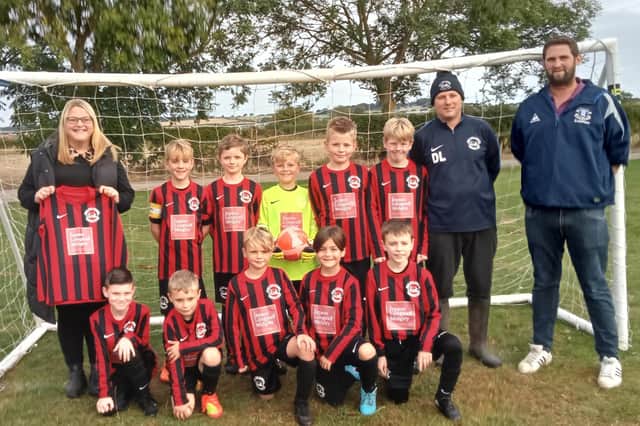 Sponsor boost for new West Pier Under-10s Reds, who line up with their coaches David Leather and Dave Brown with partner of Jepsons, Longstaff, Midgley, Haley Garton holding up a new shirt.