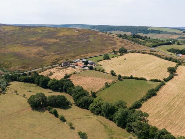 An overview of the property and its surroundings. Busco Beck Farm has a range of ancillary stone outbuildings together with more modern livestock buildings.