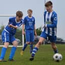 Heslerton Under-15s (blue) battle it out with York RI (blue and white). PHOTOS BY CHERIE ALLARDICE