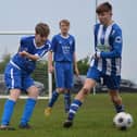Heslerton Under-15s (blue) battle it out with York RI (blue and white). PHOTOS BY CHERIE ALLARDICE