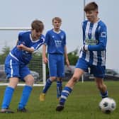 Heslerton Under-15s (blue) battle it out with York RI (blue and white). PHOTOS BY CHERIE ALLARDICE