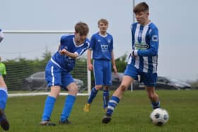 Heslerton Under-15s (blue) battle it out with York RI (blue and white). PHOTOS BY CHERIE ALLARDICE