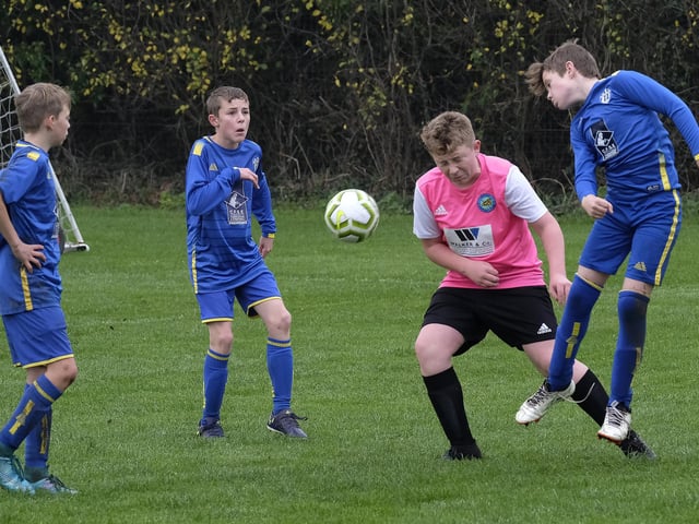Eastfield head the ball away from Ayton