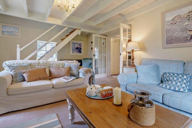 The beamed and spacious lounge, with staircase leading up to the first floor.