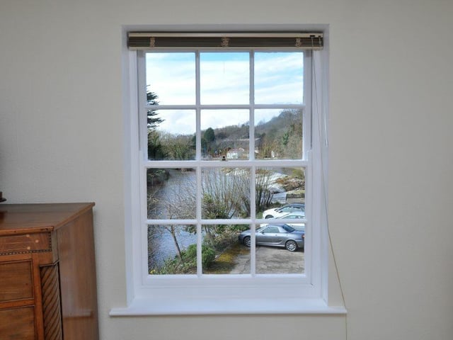 A stunning view of the river from inside the property that is currently for sale.
