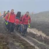 A mountain biker is stretchered to an ambulance after suffering a suspected spinal injury on the North York Moors.