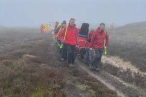 A mountain biker is stretchered to an ambulance after suffering a suspected spinal injury on the North York Moors.