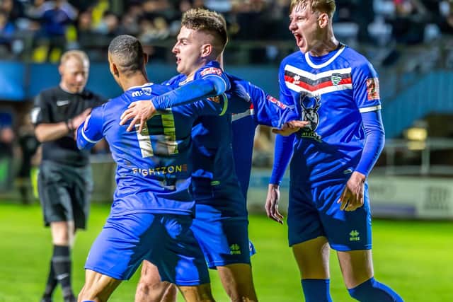 Jacob Gratton (centre) is congratulated after putting the Blues 1-0 ahead.