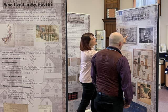 Library staff Catherine Skyvington and Thomas Bamford taking in the House History exhibition which is touring North Yorkshire’s libraries.