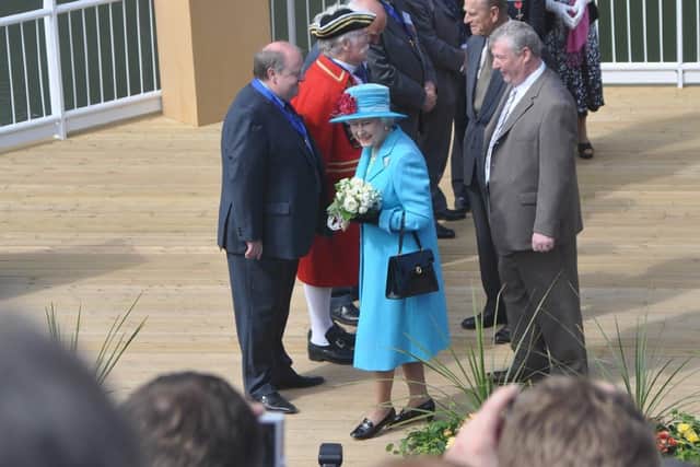 HRH Queen Elizabeth turns to greet the crowd after meeting the Freemen of the borough and Tony Peers who compered the event.