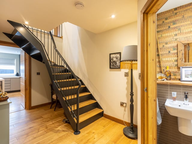 The entrance hallway with feature wrought iron staircase.