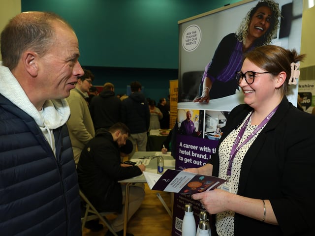 A prospective employee chats to a representative from Premier Inn South Bay