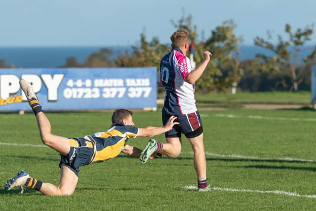 Connor Ward breaks free to score a try for the home side.