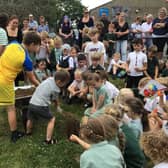 Youngsters at Whitby's Airy Hill School bury the time capsule.