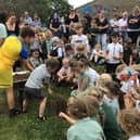 Youngsters at Whitby's Airy Hill School bury the time capsule.