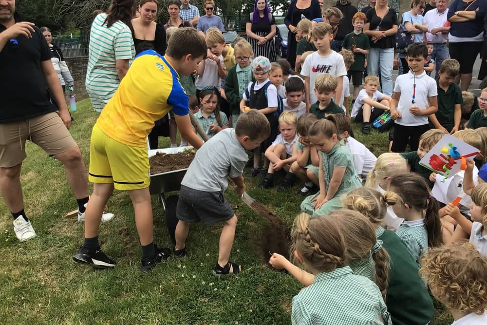 Youngsters at Whitby's Airy Hill School bury the time capsule.
