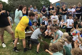 Youngsters at Whitby's Airy Hill School bury the time capsule.