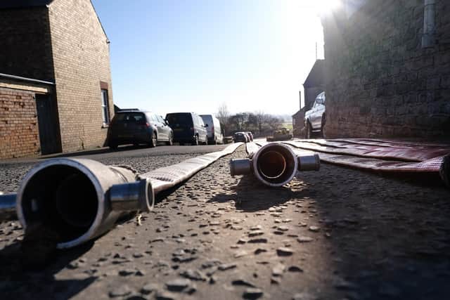 Hose reels lie at the entrance to Betton Farm