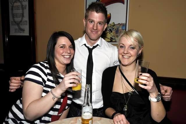 Three friends enjoy a pint.