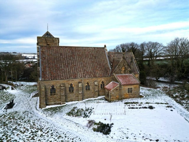 A view of the neighbouring church with countryside beyond.