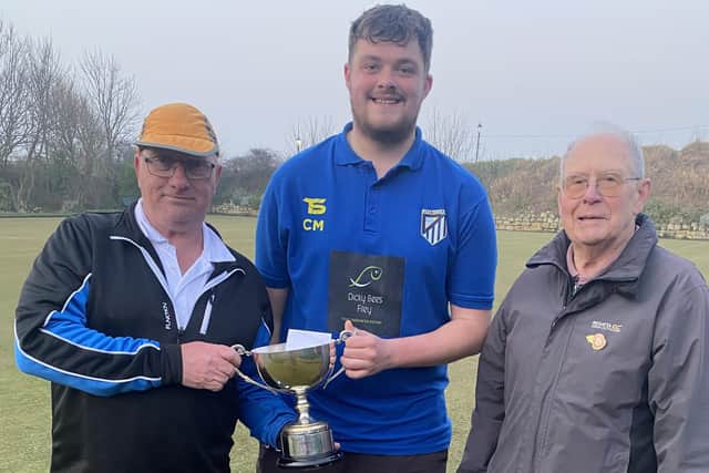 Winners Paul Morgan and Callum Malone receive the trophy from North Cliff President David Hill.