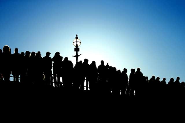 Silhouette of spectators watching the Boxing Day dip in Whitby. picture: Brian Murfield