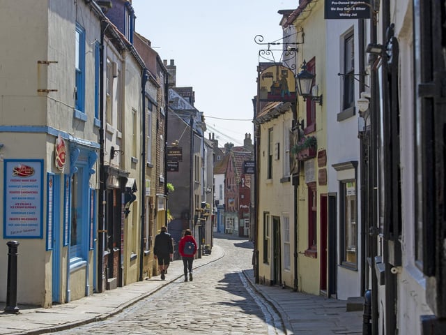 Whitby on Coronavirus lockdown - a couple take a walk along an empty Church Street.Picture: Tony Johnson