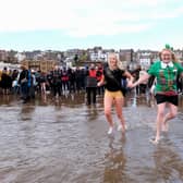 Participants having fun on South Bay at Scarborough's New Year Dip