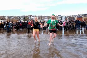 Participants having fun on South Bay at Scarborough's New Year Dip
